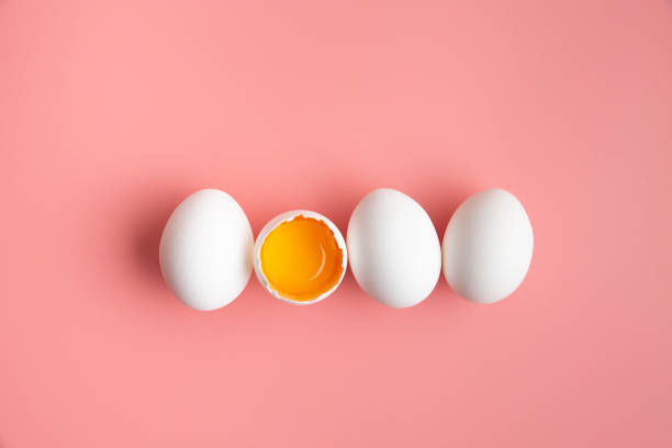 istock White eggs on pastel pink color background. Easter holiday concept. 1215236691