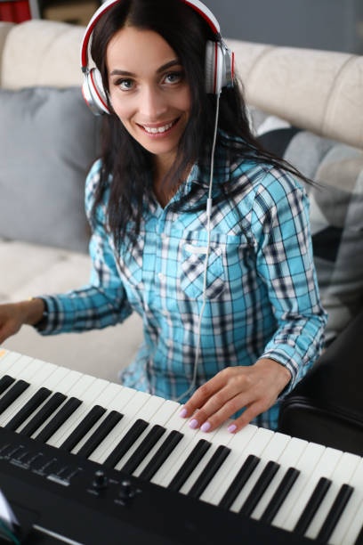 istock Girl with headphone record composition on piano 1215236750