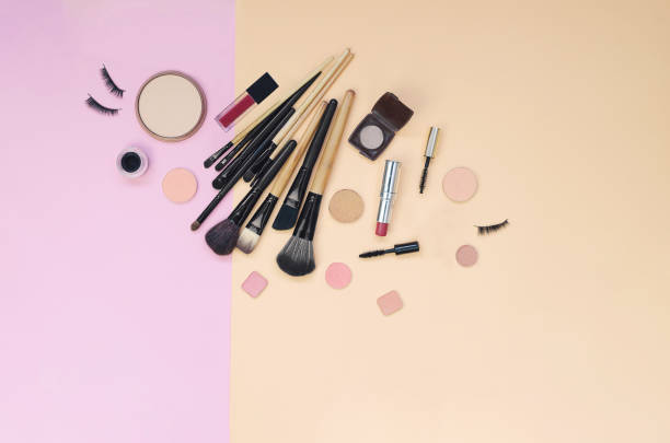 istock Colorful cosmetics lying on pink and yellow background. Flatlay 1215236768