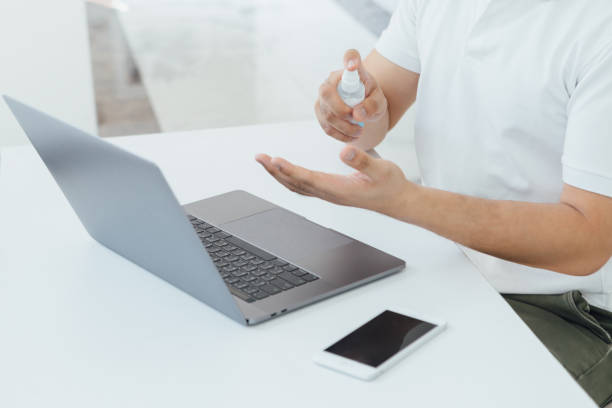 istock corona- covid19 A man coughing with mask on while working from home. 1215237014