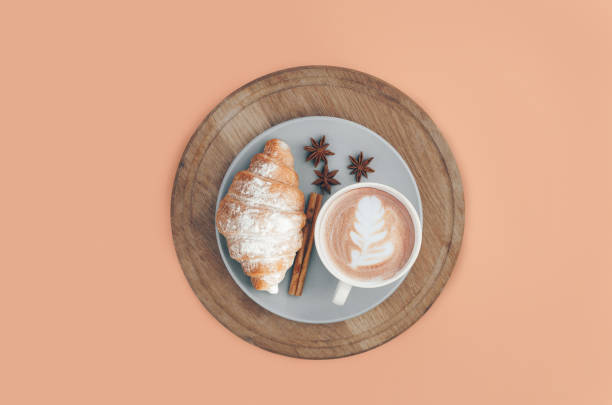 istock Fresh baked croissant with coffee cup and latte art, cinnamon 1215237585