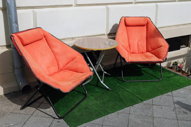 istock Two orange chairs and a round table for relaxing 1215238791