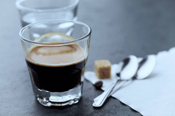 istock Coffee in glass cup on dark stone background. Close up. 1215239003