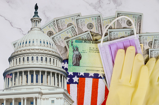 Senate stimulus deal includes individual checks virus economic stimulus plan USA dollar cash banknote on American flag Global pandemic Covid 19 lockdown