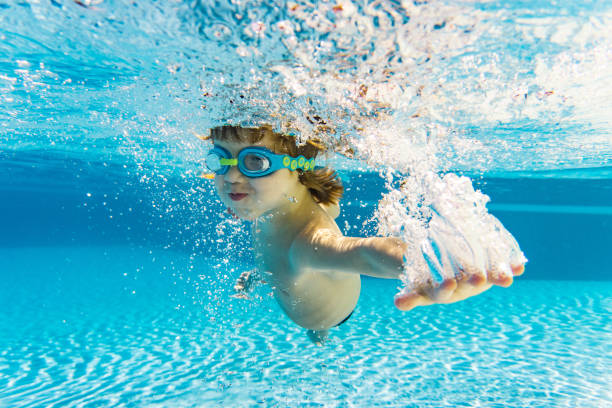 istock Little boy swimming in pool 1215239849