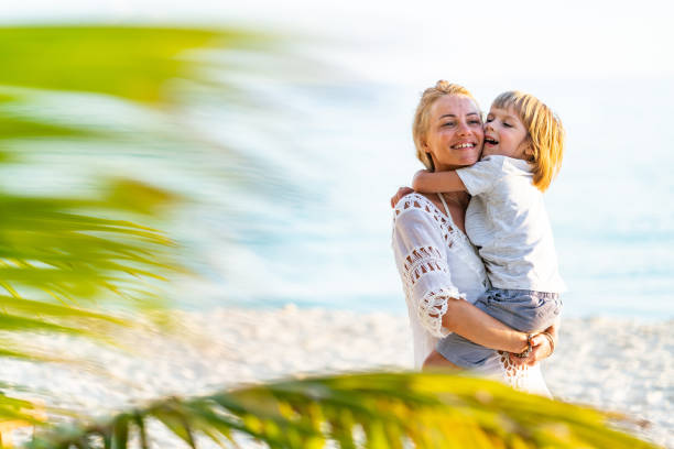 istock Mother and son hug on beach 1215239935