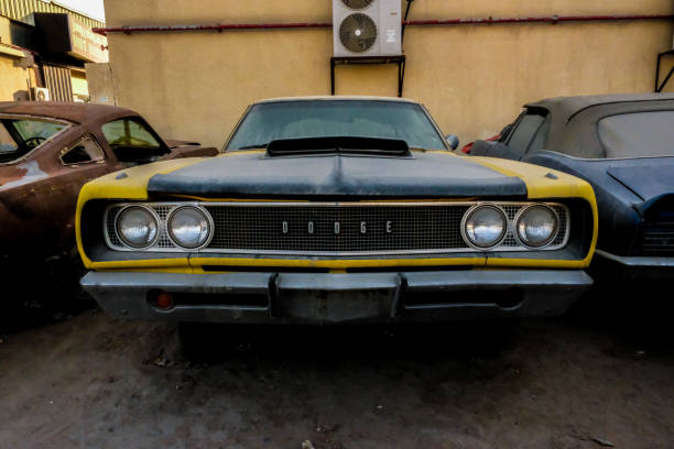 Classic cars covered in dust at a junkyard in Al Quoz, Dubai Photo taken on February 29,2020 at Dubai, UAE. Classic cars like the Datsun Z, Porsche 928 Coupe and an old school Dodge are left abandoned at an industrial area in Al Quoz. dodge charger stock pictures, royalty-free photos & images