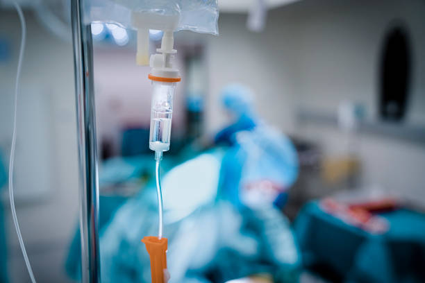 Close up of IV drip in emergency room. Healthcare worker at work during medical crisis in epidemic covid 19 virus outbreak emergency room photos stock pictures, royalty-free photos & images