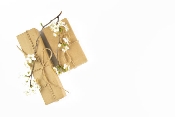 istock Banner with Wrapped in Eco craft holidays present gift boxes flower on white table top view. Flat lay styling. Copy space 1215243629