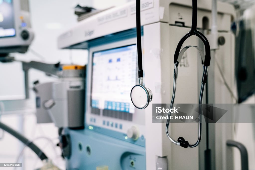 Stethoscope next to medical ventilator in emergency room. Close up of stethoscope on medical ventilator in emergency room in a hospital. Medical Equipment Stock Photo