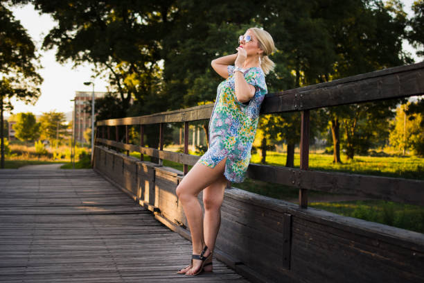 Adult woman portrait with sunglasses on the bridge