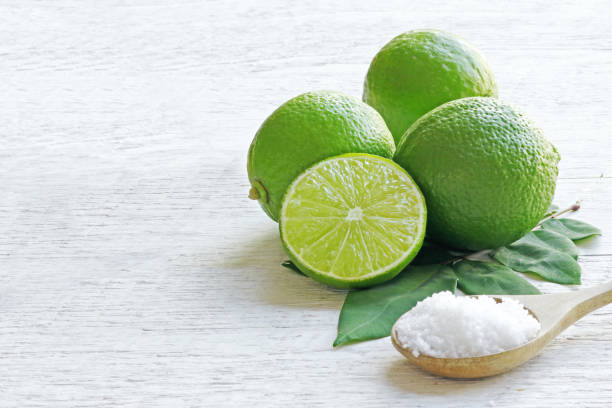 istock Lemon and lime halves salt spoon on the kitchen table. 1215245747