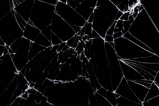 istock cracked glass isolated on a black background. 1215246665