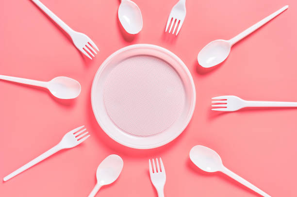 istock Disposable plastic utensils scattered on pink background. Concept of save environment, ecology, recreation on picnic, party and other events. Top view 1215246697