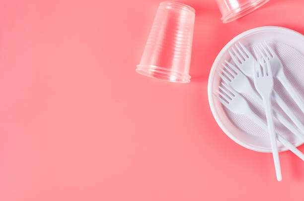 istock Disposable plastic utensils on pink background. Concept of save environment, ecology, recreation on picnic, party and other events. Copy space. Top view 1215246723