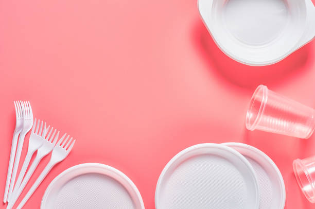 istock Disposable plastic utensils on pink background. Concept of save environment, ecology, recreation on picnic, party and other events. Copy space. Top view 1215246730