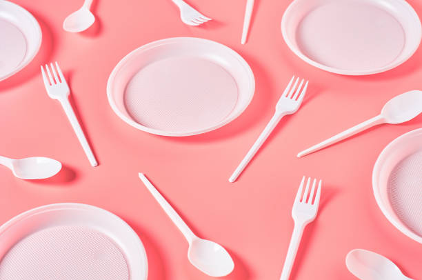 istock Disposable plastic utensils scattered on pink background. Concept of save environment, ecology, recreation on picnic, party and other events 1215246739