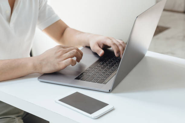 istock corona- covid19 A man coughing with mask on while working from home. 1215247443
