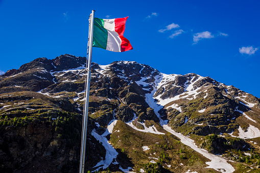 Italian flag in Alpine landscape near Santa Caterina, Adamello di Brenta, Dolomites – Italy