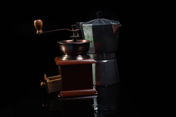 Classic Coffee Grinder and Moka Pot isolated on black with reflection