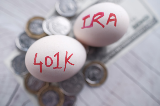 Tow eggs with the Inscription Ira Roth 401K on Money .