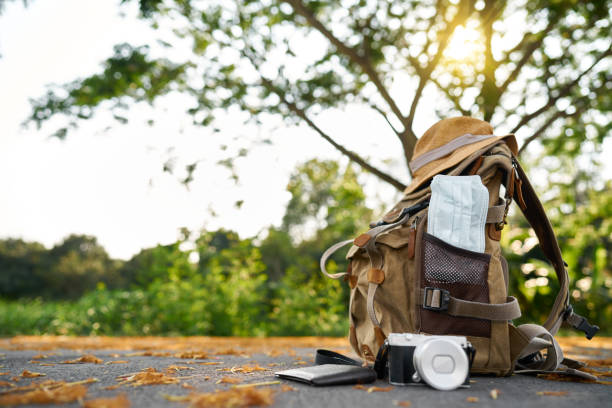 istock Prop suitcase with Corona mask with camera and purse 1215259300