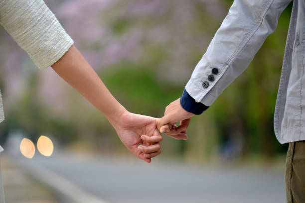 istock Love holding along pink road 1215259304