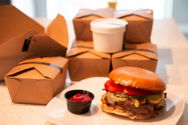 istock Burger served - take out meal and boxes on counter 1215259478