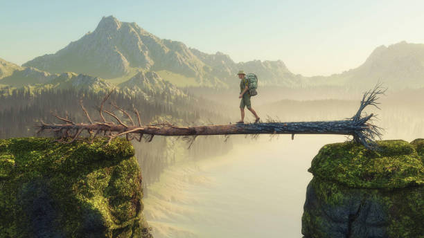 istock Traveler walking on fallen tree between two mountain rocks . This is a3d render illustration. 1215261083