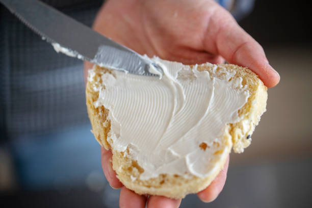 istock homemade breakfast:spreading cream cheese on toast 1215264062