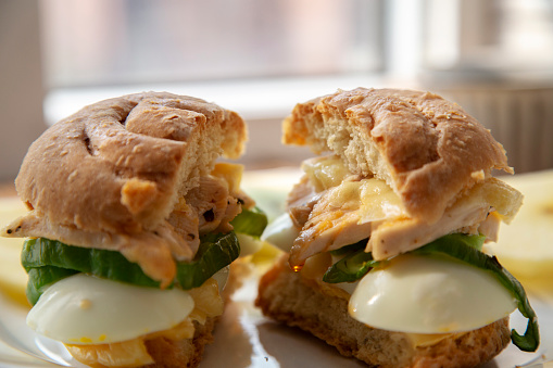 homemade breakfast: sandwich bun with egg, chicken meat and green pepper
