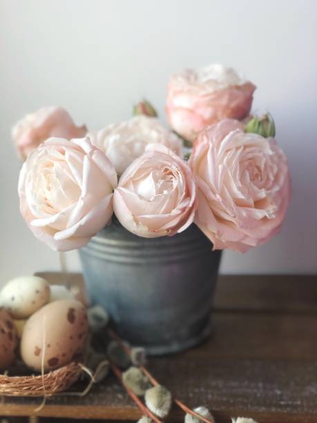 istock Rustic pink roses in a metal pot and Easter decorations 1215267431