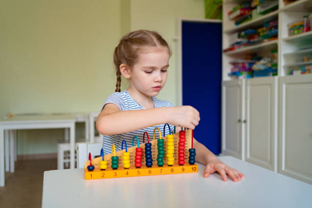 istock small girl learning to add and subtract accounts. 1215267820