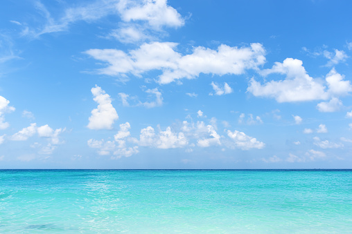 Tropical turquoise sea and blue sky with clouds