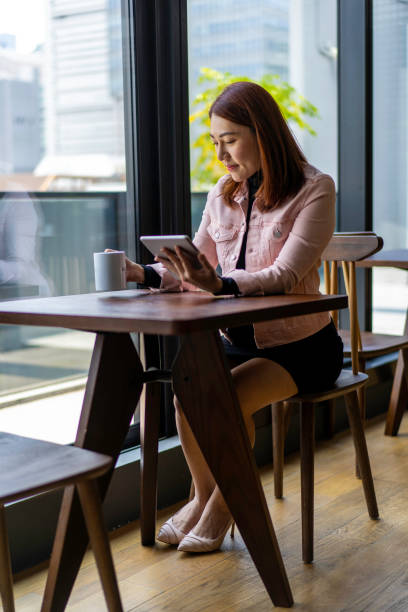 istock Asian business woman taking a coffee break 1215271822