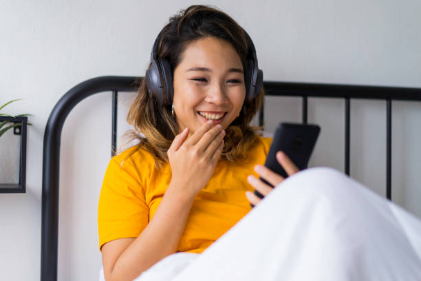 istock Young Asian woman surprised by a happy online text message. 1215271855
