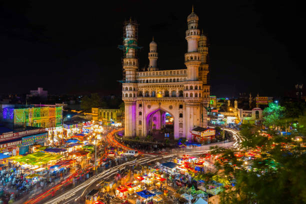 High Wide Angle View of Charminar in the Night Long Exposure Shot of Traffic moving around Charminar during ramadan season on the night of eid in hyderabad, india. hyderabad india photos stock pictures, royalty-free photos & images
