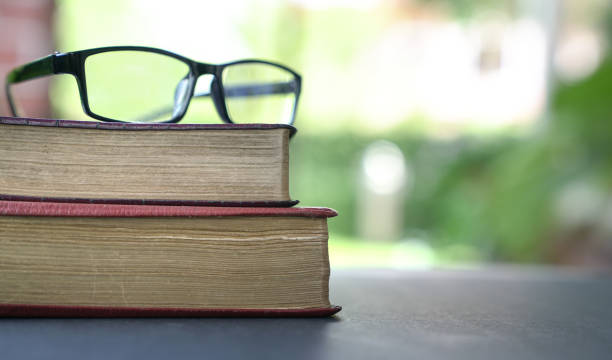 istock Reading glasses on top of books, copy space. 1215277414