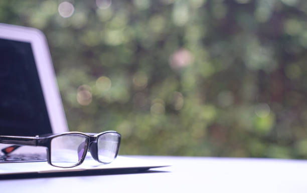 istock Reading glasses on top of computer laptop with copy space. 1215277525