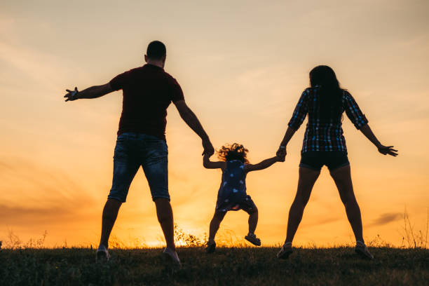 istock Family jump at sunset 1215278621