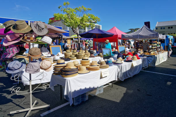 Stacks of straw hats on a Nelson market stall, Nelson, New Zealand. Nelson Market, Nelson/New Zealand - February 2, 2019: Stacks of straw hats on a Nelson market stall on a sunny day. Nelson, New Zealand. nelson city new zealand stock pictures, royalty-free photos & images