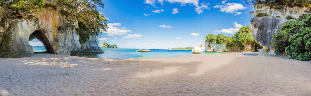 Panoramic picture of Cathedral Cove beach in summer without people during daytime Panoramic picture of Cathedral Cove beach in summer without people coromandel peninsula stock pictures, royalty-free photos & images