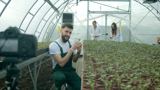 istock Young farmer recording video in a greenhouse 1215282459