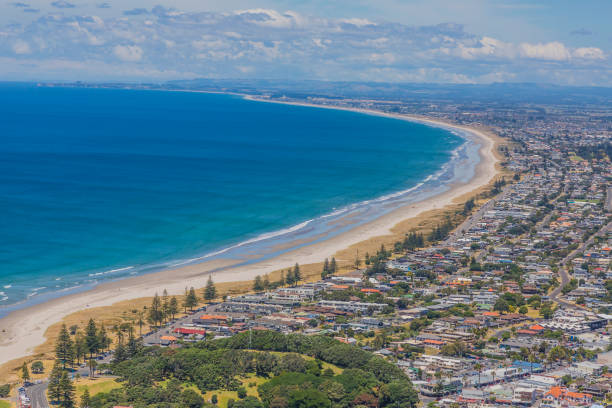 View on Touranga city and Papamoa Beach from Mount Maunganui on northern island of New Zealand in summer View on Touranga city and Papamoa Beach from Mount Maunganui on northern island of New Zealand mount maunganui stock pictures, royalty-free photos & images