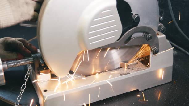 istock Sawing metal by machine in workshop. 1215289239