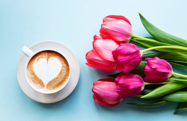 istock Coffee cup with latte art and tulips 1215289370