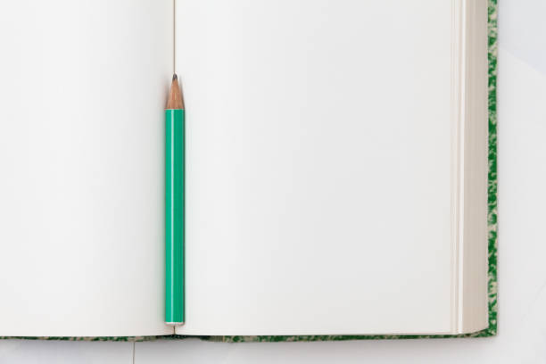 An open notebook with blank white pages and a pencil for notes. View from above. Minimalistic style