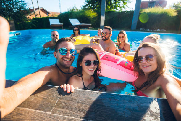 istock Selfie with friends at a poolside party 1215292509