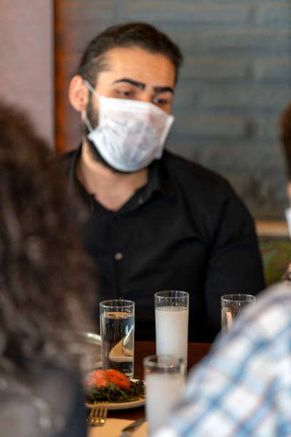 istock Business people protected from coronavirus at restaurant 1215293791