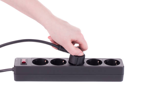 istock Hand puts the plug in an extension cord. 1215295021